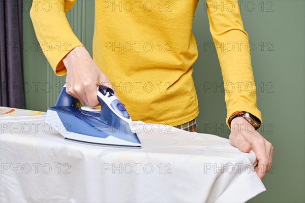 Closeup view of a man ironing his shirt