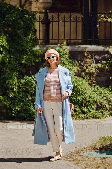 Stylish woman in blue trench coat