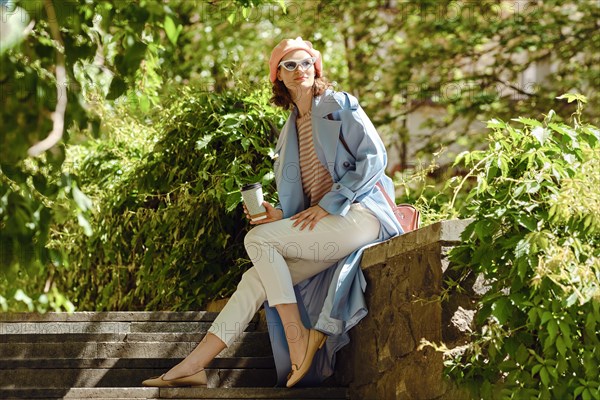 A happy woman sitting among plants