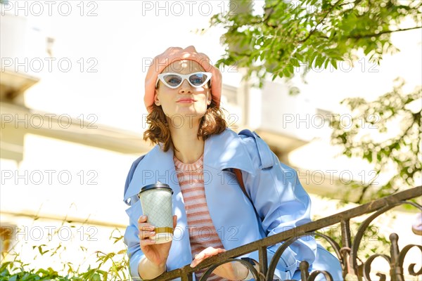 Woman surveys surroundings leaning against railing on dais