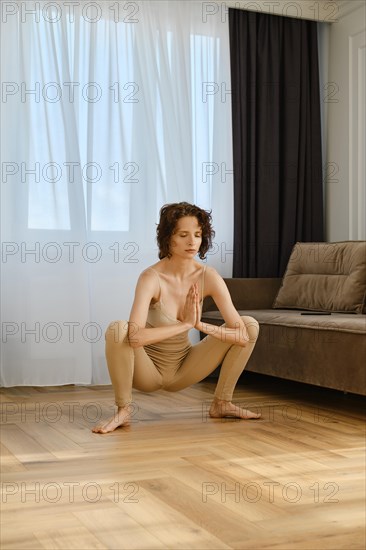 Young woman doing yoga at home