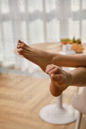 Closeup view of bare female feet in bright room