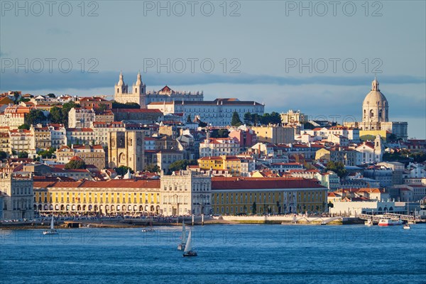 View of Lisbon over Tagus river from Almada with yachts tourist boats on sunset