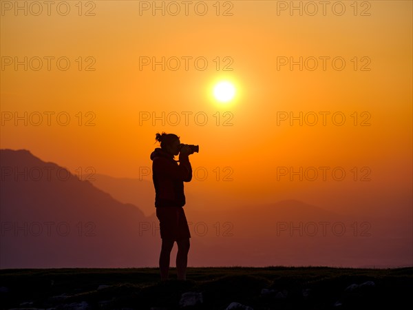 Silhouette of a photographer at sunset