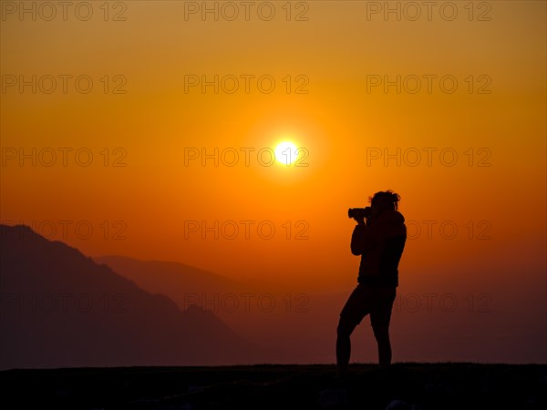 Silhouette of a photographer at sunset