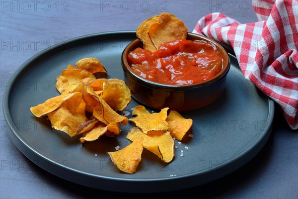 Sweet crisps and salsa sauce on plate