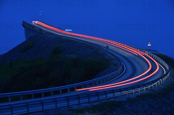 Car taillight on the Storseisund Bridge on the Atlantic Road