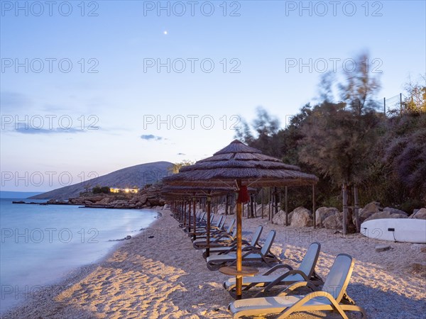 Sunshades and sunbeds on the sandy beach