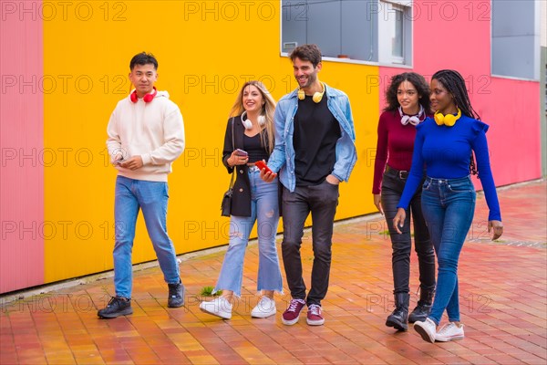 Group of multi-ethnic friends walking on university campus having fun