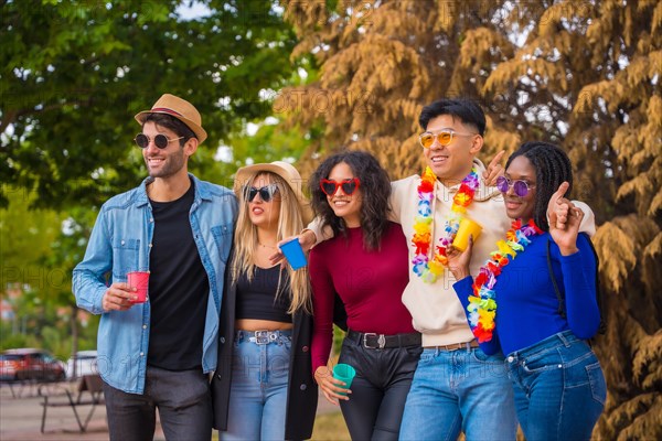 Group portrait of multi ethnic friends having a party in a park