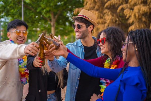 Group of multi ethnic friends at a party in a park having fun