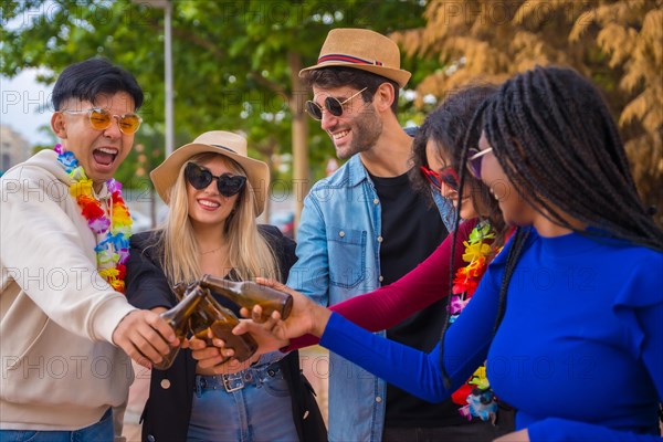 Group of multi ethnic friends at a party in a park having fun