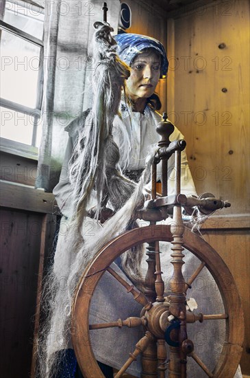 Figure of a flax spinner with spinning wheel