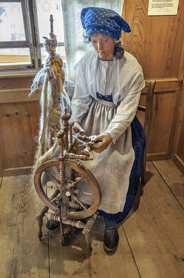 Figure of a flax spinner with spinning wheel