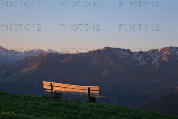 Viewpoint or bench in the sunrise with a view of the mountains of the Bavarian Alps and the Karwendel