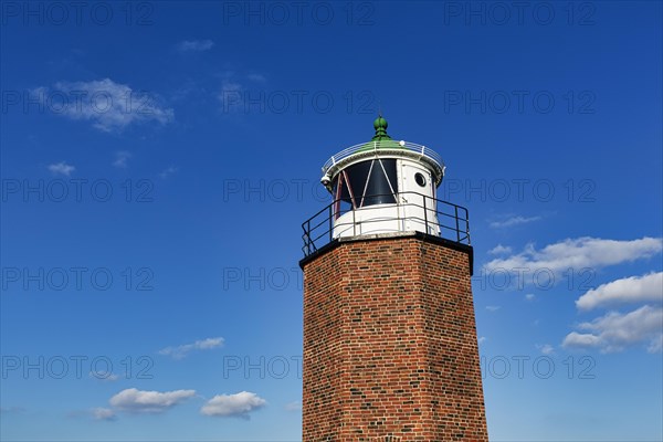 Octagonal brick cross light against blue sky