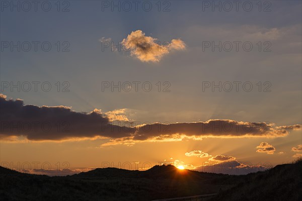 Sunset behind dunes