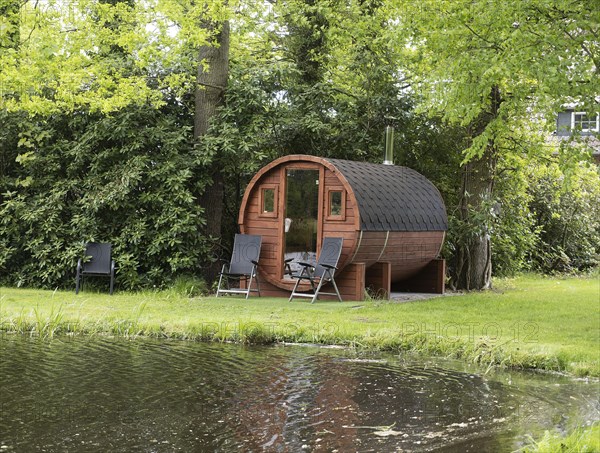 Sauna barrel with adjacent pond