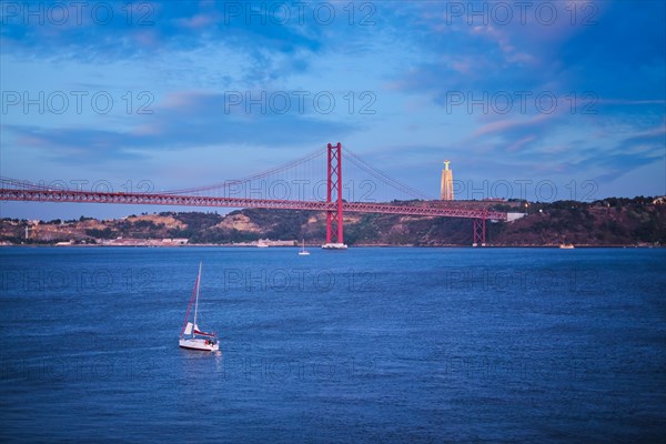 View of 25 de Abril Bridge famous tourist landmark over Tagus river