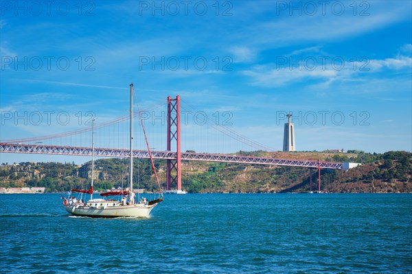 View of 25 de Abril Bridge famous tourist landmark over Tagus river