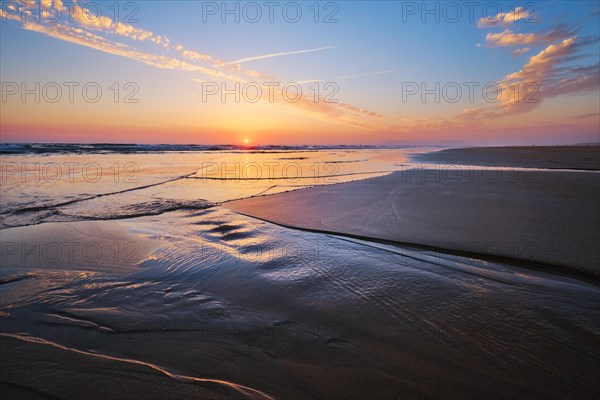 Atlantic ocean sunset with surging waves at Fonte da Telha beach