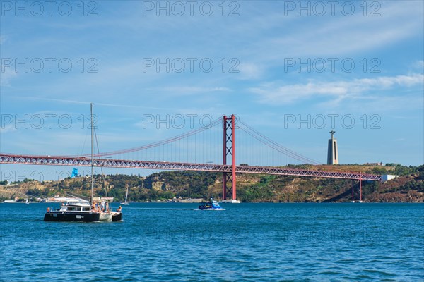 View of 25 de Abril Bridge famous tourist landmark over Tagus river