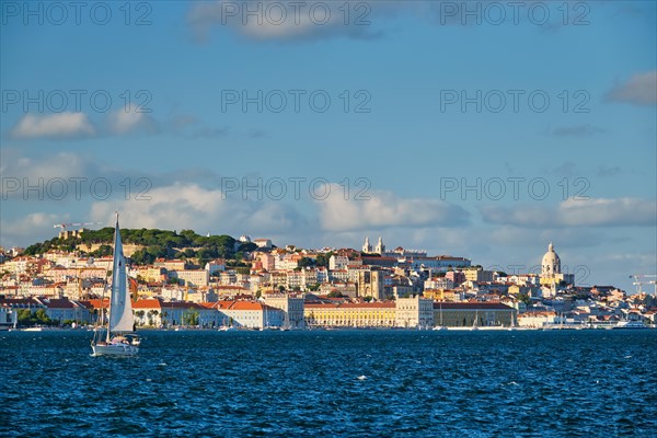 View of Lisbon over Tagus river from Almada with yachts tourist boats on sunset