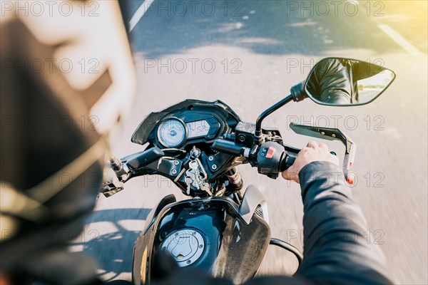 Close up of motorcyclist driving his motorbike on the street