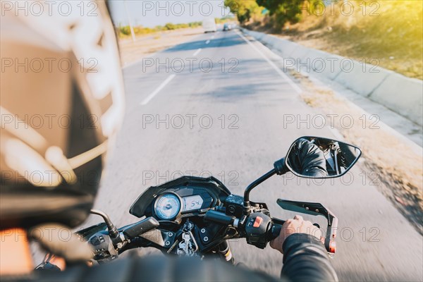 View of hands of biker driving his motorbike