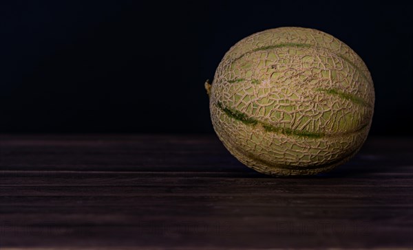 Cantaloupe melon on black background dark food