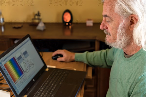 Modern alternative medical treatment concept: Man treating a patient remotely with quantum medicine analysis