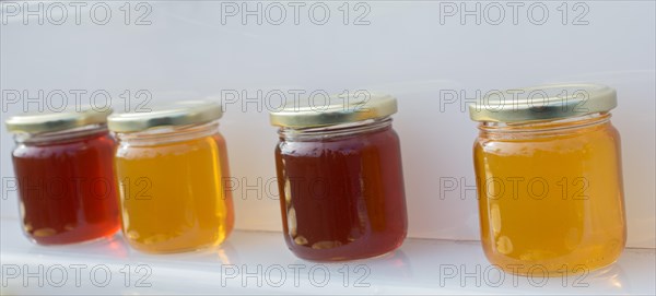 Glass jar of full of fresh honey with lid