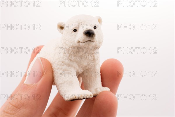 Hand holding White Polar bear model