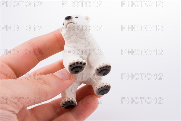 Hand holding White Polar bear model
