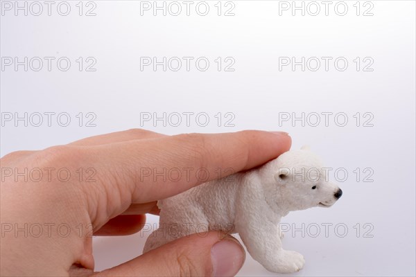 Hand holding White Polar bear model