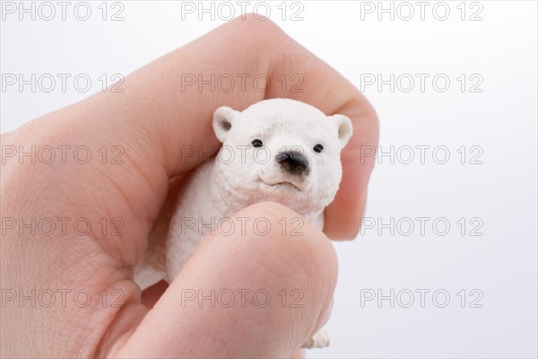 Hand holding White Polar bear model