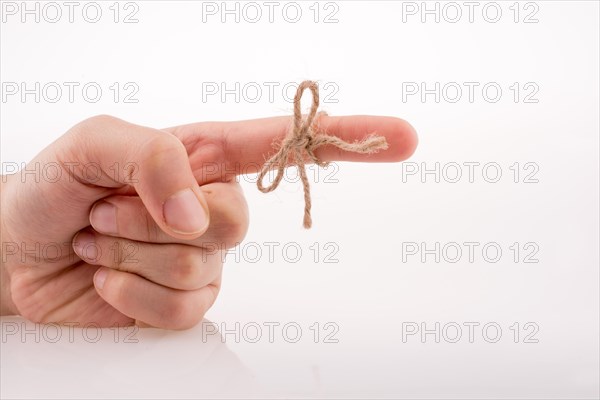 Hand tied with a thread like a ribbon on a white background