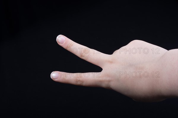 The sign of victory and peace in black background