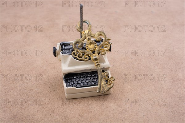 Retro syled tiny typewriter model on a white background