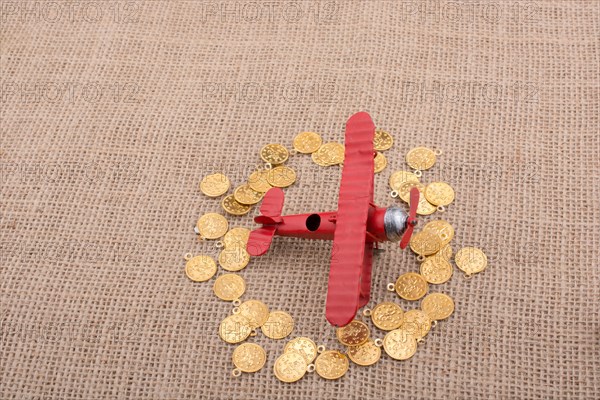 Fake gold coins around the retro model airplane