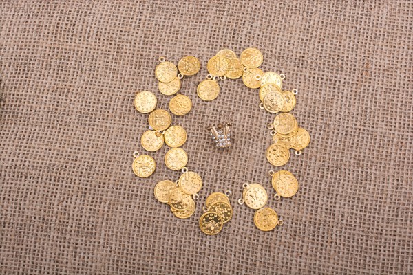 Fake gold coins are around the little model crown