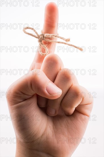 Hand tied with a thread like a ribbon on a white background