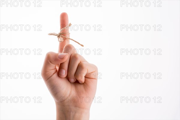 Hand tied with a thread like a ribbon on a white background