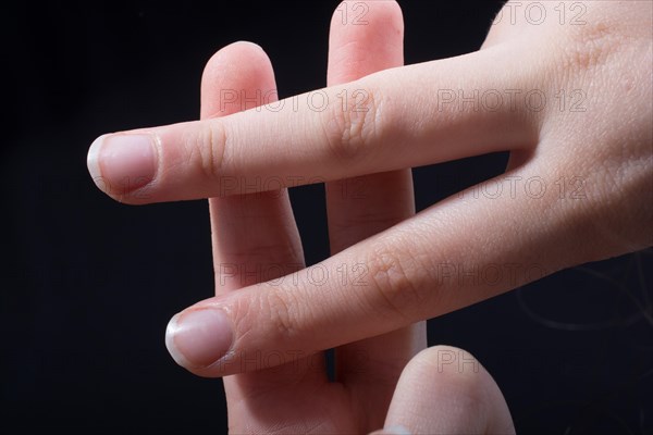 Fingers forming a hashtag symbol isolated on black background