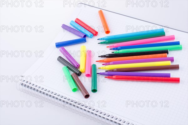 Colorful felt-tip pens on a notebook