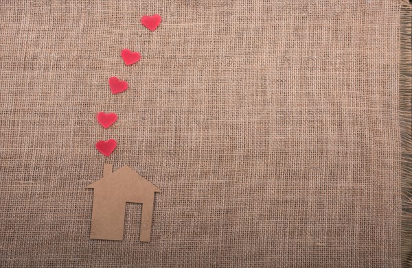 Heart shape coming out of chimney of paper house