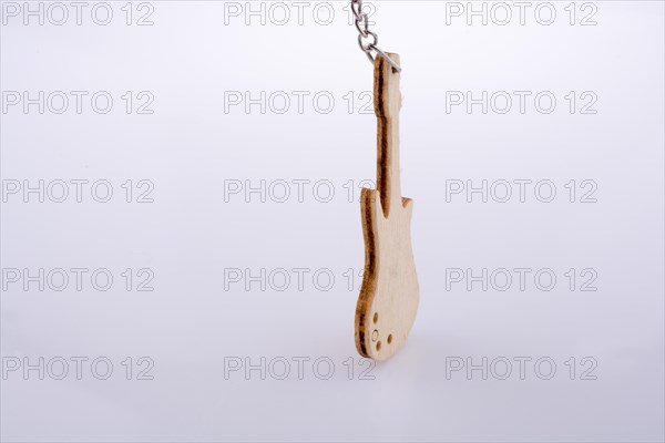 Mini wooden guitar model on a white background