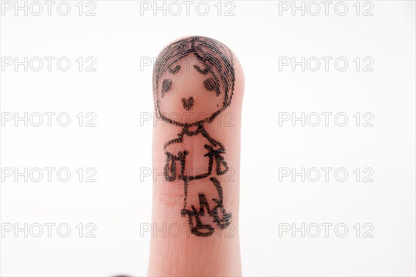 Child figure drawn on a finger tip with black color