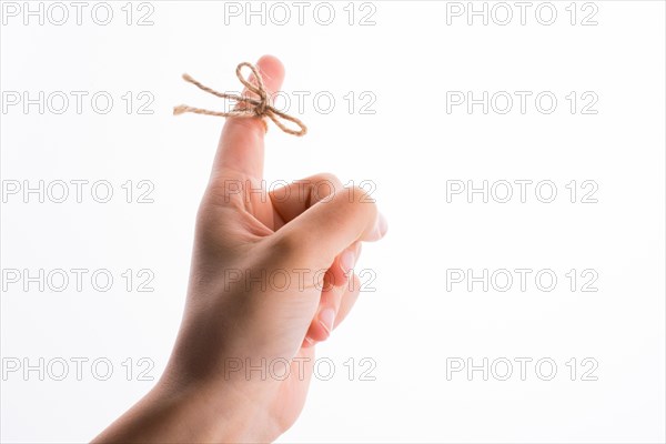 Hand tied with a thread like a ribbon on a white background
