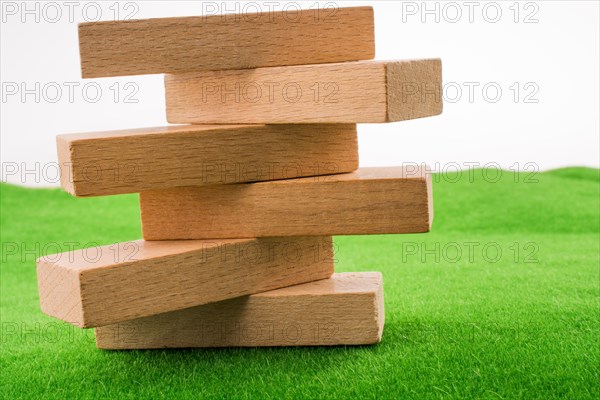 Wooden dominos on green grass